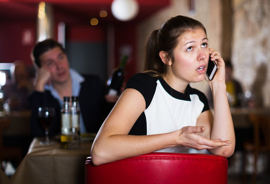 Unhappy woman talking on phone