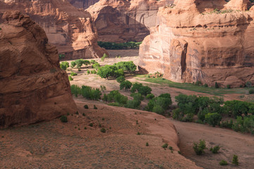 View of cliffs and canyon in dramatic light from the Junction Overlook at Canyon de Chelly National Monument in Arizona