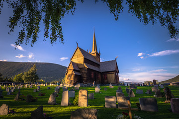 Fototapeta na wymiar Lom - July 29, 2018: The Stave Church of Lom, Norway