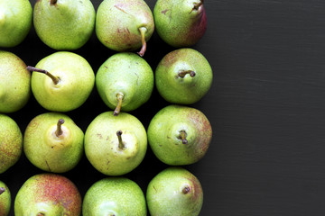 Top view fresh pears on dark background. From above, overhead, flat lay. Copy space.