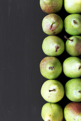 Fresh pears on black background, overhead view. From above, flat lay. Copy space.