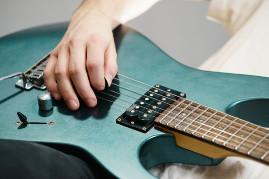 Close up of man playing on electric guitar