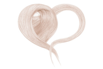 Blond hair in shape of heart on white background
