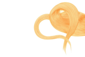 Blond hair in shape of heart on white background