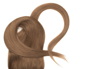 Brown hair in shape of heart on white background