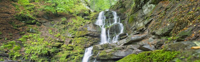panoramic view to waterfall in canyon