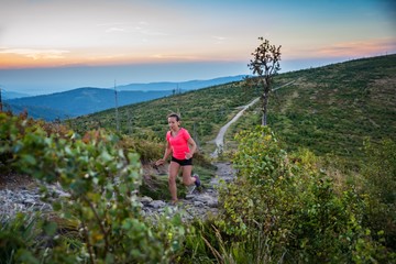 Fototapeta na wymiar Woman trail running in mountains.