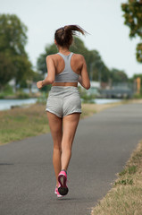 portrait on back view of sexy girl  running in border channel