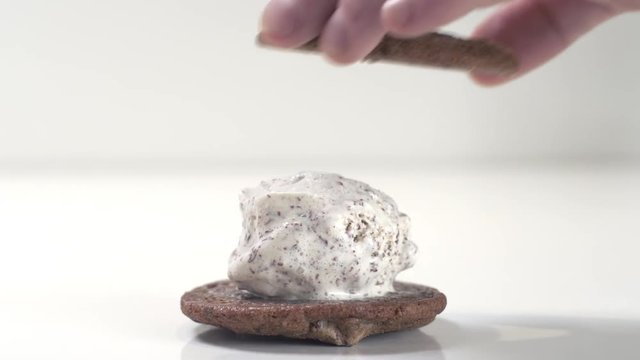 Close up shot of delicious soft mint chocolate chip ice cream sandwiched between two fresh cookies