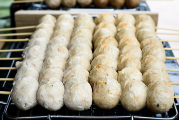 Beef meatballs grill on the electric stove , thai street food