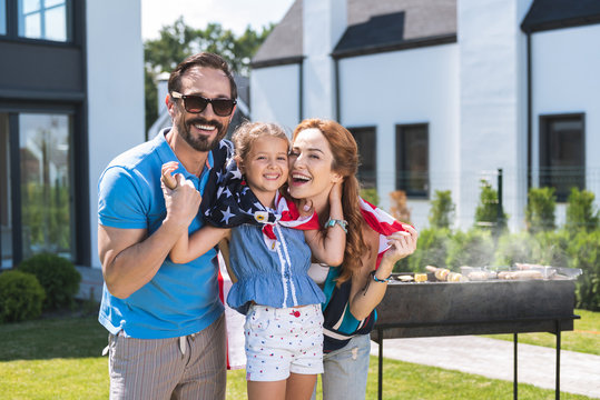 National weekend. Happy American family having a barbeque while celebrating the independence day - Powered by Adobe