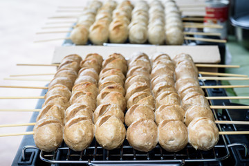 Beef meatballs grill on the electric stove , thai street food