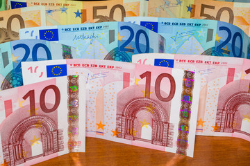Close Up Euro Money Banknotes. cash Background. Money Bills On The Table In Vertical Position. Finance And Economy Concept.
