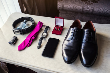 different accessories of a businessman for creating a style of a people lie on a wooden background