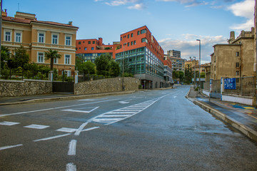 Colorful urban concept of small city empty street district with road without car and architecture buildings facade in bright contrast  summer day time