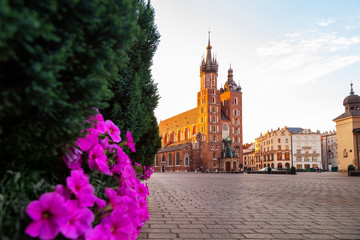 Naklejka na ściany i meble St. Mary's Basilica in Krakow, Poland, famous brick church with two towers, located on the market square in the historic centre at sunrise.