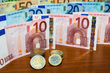 Close Up Euro Money Banknotes And Coins. cash Background. Money Stacks And Bills On The Table In Vertical Position. Finance And Economy Concept.