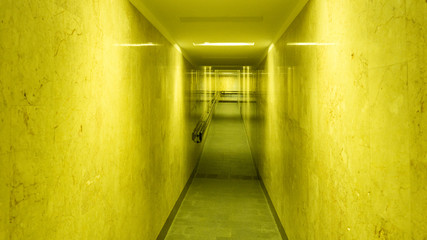 Tunnel, a long corridor at the end of which is light. Basement with illuminated walls. Neon