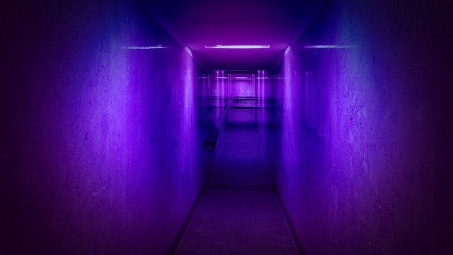 Tunnel, a long corridor at the end of which is light. Basement with illuminated walls. Neon