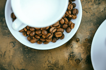 Coffee beans Close-up of coffee cup with roasted coffee beans on textures background View from top cappuccino Espresso dark