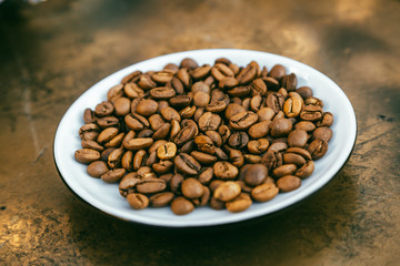 Coffee beans Close-up of coffee cup with roasted coffee beans on textures background View from top cappuccino Espresso dark