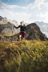 Adventurous Sportive Girl hiking in Beautiful Alpine Mountains