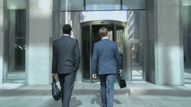 Business people going to office center, communicating, beginning of work day
