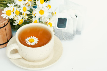 cup of herbal chamomile tea with camomile dry blossoms, dried camomile flowers. doctor treatment and prevention of immune concept, medicine - folk, alternative, complementary, traditional medicine 