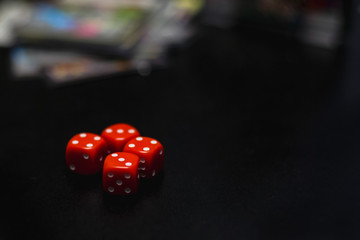 red dice on a black table, board game