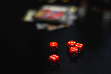 red dice on a black table, board game
