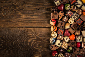 pralines on the wooden plank background