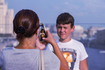 mom takes pictures of her son on the phone