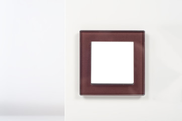 light switch with glass frame on the wall