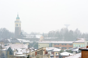 Winter unusual aerial landscape of Rovigo in Veneto in the Po valley, Italy. During a snowfall the city roofs got white even the historic landmark as the Rotonda church and its bell tower