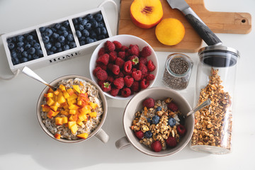 Breakfast set. Porridge with sliced apricot, berries and granola