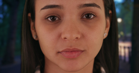 Hispanic beauty stares intently at partner in the park