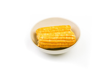 boiled corn on a plate on a white background. Isolate. Close-up