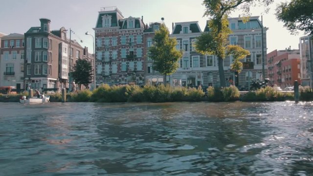 Being on a boat tour, through Amsterdam in the afternoon.
