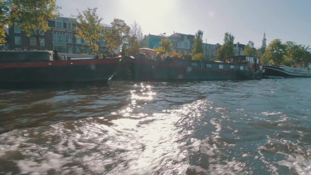 Being on a boat tour, through Amsterdam in the afternoon.