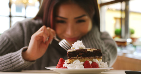 Happy Japanese woman indulges in fancy dessert