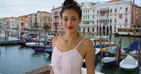 Fototapeta na wymiar Smiling portrait of sultry Latina woman in white sundress near Grand Canal