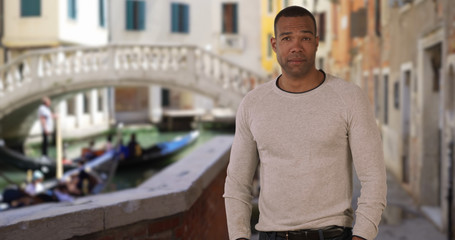 Confident African male stands proudly while traveling in Venice Italy