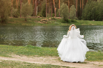 Fototapeta na wymiar Wedding day. Bride on the nature. Summertime