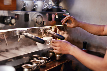 Fototapeta na wymiar Preparing Drink In Coffee Machine By Barista At Cafe