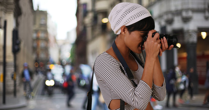 Modern black woman millennial taking shots of London city on camera 