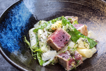 Modern style fried tuna fish tataki filet salad with white asparagus sugar snaps and parmesan...