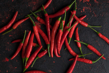 Red hot chili peppers on old wooden table with place for text