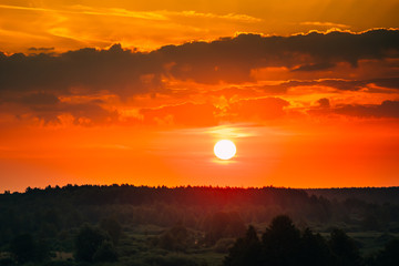 Obraz premium Sunrise Over Forest Landscape. Scenic View Of Sunset Sky With Sun