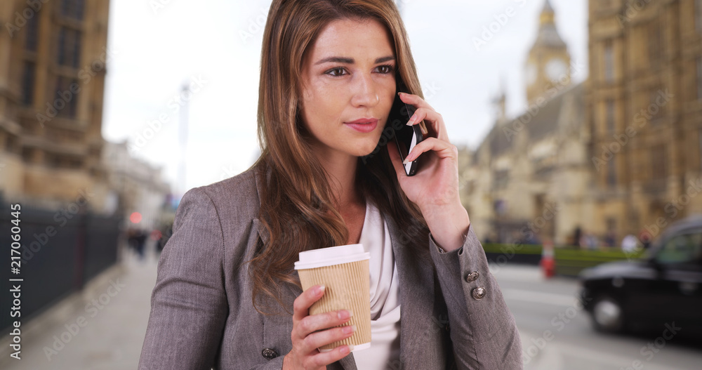 Wall mural Caucasian female on business trip in London calling to confirm meeting