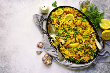 Classic valencian paella from rice with seafood and green pea - traditional dish of spanish...